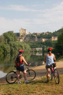 06-7562 Female Cyclist and View to Beynac-at-Cazenac, Dordogne Valley, France